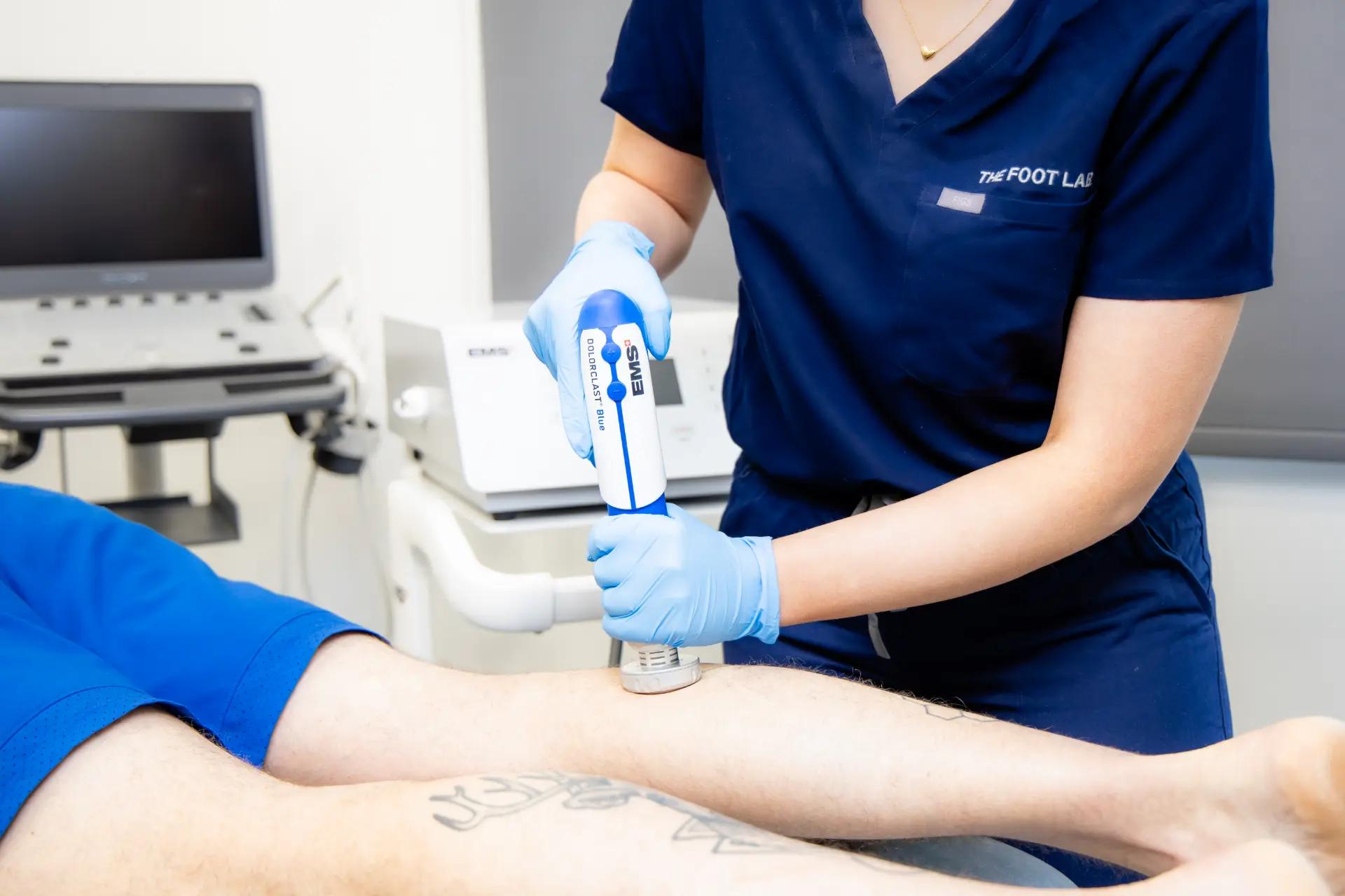 Podiatrist assessing a patient’s foot in the treatment chair at The Foot Lab podiatry clinic, Glossop